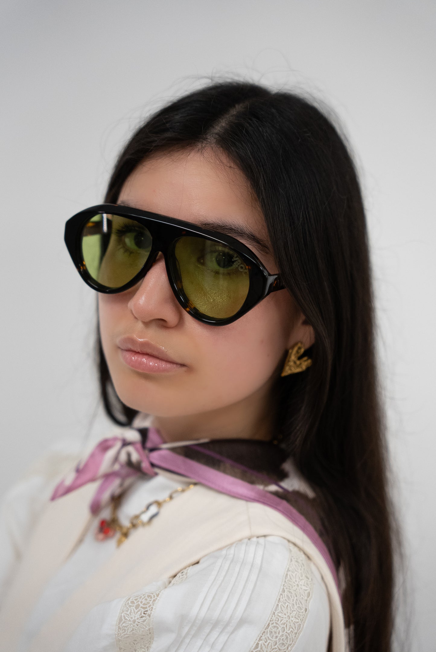 photo de face d'une femme qui porte des Lunettes de soleil vert profond inspiré des tonalités naturelles de la marque VROC.